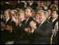 Sitting with the U.S. Ambassador to Mexico Tony Garza, President George W. Bush and Laura Bush applaud the performances during a White House ceremony honoring Cinco de Mayo in the East room Wednesday, May 5, 2004. "The great triumph of Mexican forces on May the 5th, 1862, has inspired liberty-loving people everywhere, and it's helped shape the character of modern Mexico," said the President remarked on the history of the date. "Against great odds, a small and under-equipped army defeated the skilled army of a European power. We've had that experience in America, too." White House photo by Paul Morse