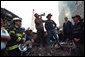 Standing upon the ashes of the worst terrorist attack on American soil, Sept. 14, 2001, President Bush pledges that the voices calling for justice from across the country will be heard. Responding to the Presidents' words, rescue workers cheer and chant, "U.S.A, U.S.A." White House photo by Eric Draper