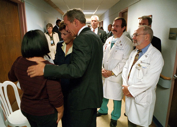 President George W. Bush and First Lady Laura Bush comfort a family member of a victim of the Pentagon terrorist attack during a visit to Washington Hospital Center, Thursday, Sept. 13, 2001. White House Photo by Eric Draper.