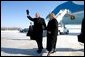 President George W. Bush escorts Freedom Corps Greeter Beverly Christy-Wright after his arrival in Milwaukee, Wisconsin, Monday, Feb. 20, 2006. The President presented Beverly with the President's Volunteer Service Award. White House photo by Eric Draper