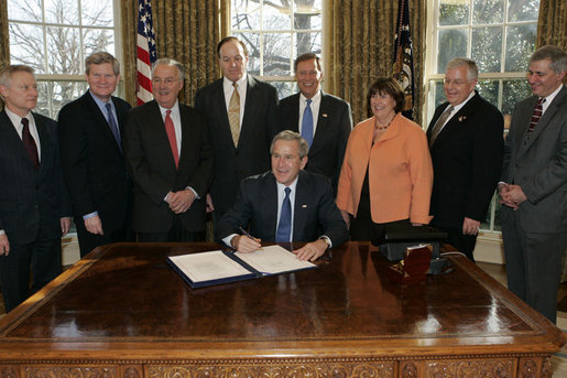 President George W. Bush is joined by legislators and the chairman of the Federal Deposit Insurance Corporation, Wednesday, Feb. 15, 2006 in the Oval Office, as he signs H.R. 4636- The Federal Deposit Insurance Reform Conforming Amendments Act of 2005. From left to right are U.S. Rep. Spencer Bachus, R-Ala., U.S. Sen. Tim Johnson, D-S.D., U.S. Sen Paul Sarbanes, D-Md., U.S. Sen. Richard Shelby, R-Ala., U.S. Rep. Mike Oxley, R-Ohio, U.S. Rep. Darlene Hooley, D-Ore., U.S. Sen. Mike Enzi, R-Wyo., and Martin Gruenberg, acting chairman of the Federal Deposit Insurance Corporation. White House photo by Kimberlee Hewitt