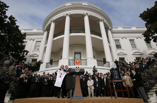President George W. Bush holds up a University of Texas Longhorns jersey with head football coach Mack Brown, Tuesday, Feb. 14, 2006 on the South Lawn of the White House, during ceremonies to honor the 2005 NCAA Football Champions. White House photo by Paul Morse