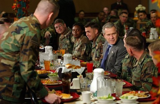 President George W. Bush enjoys lunch with U.S. soldiers at Fort Carson, Colorado Nov. 24, 2003. White House photo by Tina Hager