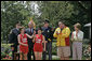 Runners Karen Dickerson of Springfield, Va., and Qiao Meili of Shanghai, China, hold up the lit torch during a Special Olympics Global Law Enforcement Torch Run Ceremony Thursday, July 26, 2007, in the Rose Garden. White House photo by Joyce N. Boghosian