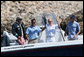 With former President George H.W. Bush and President George W. Bush looking on, Russia's President Vladimir Putin holds up his catch Monday, July 2, 2007, with the help of fishing guide Billy Bush, during a morning outing at Walker's Point in Kennebunkport, Me. White House photo by Eric Draper