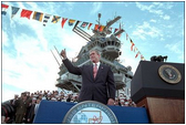 Addressing veterans, servicemen and women and families, President George W. Bush gives a thumbs-up during his speech marking the anniversary of Pearl Harbor on the U.S.S. Enterprise Dec. 7, 2001. "What happened at Pearl Harbor was the start of a long and terrible war for America. Yet, out of that surprise attack grew a steadfast resolve that made America freedom's defender. And that mission -- our great calling -- continues to this hour, as the brave men and women of our military fight the force of terror in Afghanistan and around the world," said the President.