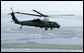 U.S. Marine One carrying President George W. Bush flies above a bridge construction project Monday, Aug. 28, 2006, on a flight from Mississippi to Louisiana, where President Bush is on a two-day visit to the Gulf Region to assess the region’s recovery and rebuilding efforts a year after the devastation of Hurricane Katrina. White House photo by Eric Draper