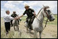 President George W. Bush meets with mounted U.S. Border Patrol agents along the U.S.-Mexico border Thursday, Aug. 3, 2006, in the Rio Grande Valley border patrol sector in Mission, Texas. White House photo by Eric Draper