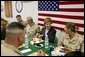 Laura Bush laughs with troops as they eat dinner in the Dragon Chow Dining Hall on Bagram Air Base in Kabul, Afghanistan Wednesday, March 30, 2005. White House photo by Susan Sterner