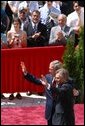 President George W. Bush and President of Poland Aleksander Kwasniewski acknowledge the audience following their speeches in the court yard of the Wawel Royal Palace in Krawkow, Poland, Saturday, May 31, 2003. White House photo by Paul Morse