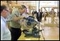 President George W. Bush takes a turn at a table saw during a Labor Day tour of the Carpenters Joint Apprenticeship Center on Neville Island, Pennsylvania.  