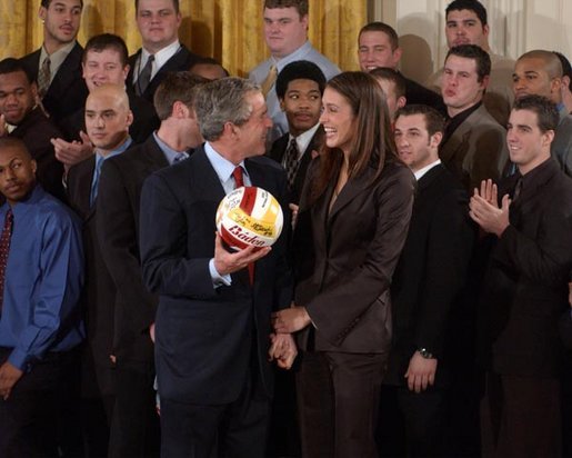 President George W. Bush talks with Lauren Killian, captain of the women's volleyball team at University of Southern California, during a visit by the NCAA Fall Champions to the East Room Monday, Feb. 24, 2003. White House photo by Tina Hager