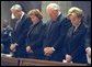 Bowing their heads in prayer, NASA Administrator Sean O'Keefe, far left, Laura O'Keefe, left, Vice President Dick Cheney, center, and Lynne Cheney attend a memorial service for the Space Shuttle Columbia astronauts at the National Cathedral in Washington, D.C., Thursday, Feb. 6, 2003. The seven astronauts died when the space shuttle broke apart upon re-entering the atmosphere Feb. 1, 2003. White House photo by David Bohrer