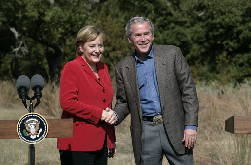 President George W. Bush and German Chancellor Angela Merkel greet each other at the end of their press conference at the Bush Ranch in Crawford, Texas, Saturday, Nov. 10, 2007. White House photo by Eric Draper