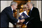 President George W. Bush, joined by The Dalai Lama, welcomes Nobel Peace Laureate Elie Wiesel, Wednesday, Oct. 17, 2007, to the ceremony at the U.S. Capitol in Washington, D.C., for the presentation of the Congressional Gold Medal to The Dalai Lama. White House photo by Chris Greenberg