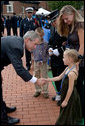 President George Bush greets and offers comfort to friends and family members of firefighters who lost their lives in the line of duty, during a ceremony at the National Fallen Firefighters Memorial in Emmitsburg, Md., Sunday, Oct. 7, 2007. White House photo by Chris Greenberg