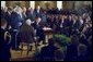 President George W. Bush looks toward Senator Jesse Helms after signing the H.J. Resolution 114 authorizing the use of force against Iraq in the East Room Wednesday, Oct. 16. "I thank the Congress for a thorough debate and an overwhelming statement of support. The broad resolve of our government is now clear to all, clear to everyone to see: We will defend our nation, and lead others in defending the peace," said President Bush. White House photo by Paul Morse.