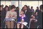 Laura Bush applauds at the end of a reading by renowned children's author and illustrator, Eric Carle Saturday, October 12, 2002 at the Second Annual National Book Festival on the held on the west side of the Capitol. White House photo by Susan Sterner.