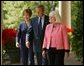 President George W. Bush and First Lady Mrs. Laura Bush walk down the colonnade with Kathleen Mellor of South Kingstown, Rhode Island before presenting her with the 2004 Teacher of the Year award in the Rose Garden of the White House on April 21, 2004. White House photo by Paul Morse