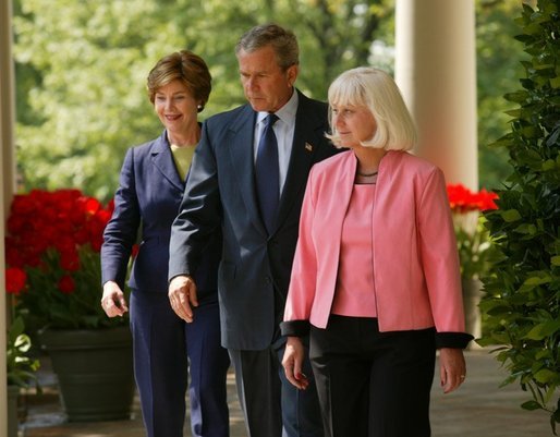 President George W. Bush and First Lady Mrs. Laura Bush walk down the colonnade with Kathleen Mellor of South Kingstown, Rhode Island before presenting her with the 2004 Teacher of the Year award in the Rose Garden of the White House on April 21, 2004. White House photo by Paul Morse