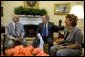 President George W. Bush meets with the newly-elected President of the National Olympic Committee of Iraq, Ahmed Al-Samarrai, left, and Dr. Iman Sabeeh, member of the Executive Office of the NOCI, in the Oval Office Monday, April 19, 2004. White House photo by Eric Draper.