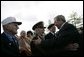 President George W. Bush greets veterans at the Netherlands American Cemetery in Margraten Sunday, May 8, 2005, following a ceremony honoring those who served in World War II. White House photo by Eric Draper