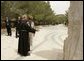 Father Michele Piccirillo, head of the Franciscan Archeology Society, discusses a monument with Laura Bush during her tour of Mount Nebo in Jordan Saturday, May 21, 2005. White House photo by Krisanne Johnson