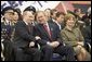 President George W. Bush and Russian President Vladimir Putin share a light moment as they sit with Laura Bush and other heads of state during a military parade marking the end of World War II in Moscow's Red Square, Monday, May 9, 2005. White House photo by Eric Draper