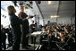 President George W. Bush looks toward conductor JoAnn Falletta as he directs the Virginia Symphony Orchestra Sunday, May 13, 2007, during the celebration marking the 400th anniversary of the Jamestown Settlement. White House photo by Eric Draper