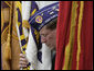 A flag bearer for the Military Order of the Purple Heart bows his head during the Memorial Day commemoration ceremony Monday, May 28, 2007, at Arlington National Cemetery in Arlington, Va. White House photo by Joyce Boghosian