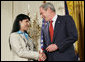 President George W. Bush shakes hands with military spouse Michele Langford of Alameda, Calif., a recipient of the President’s Volunteer Service Award Friday, May 11, 2007, presented in the East Room of the White House during a celebration of Military Spouse Day. White House photo by Eric Draper