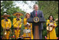 President George W. Bush welcomes guests to the Rose Garden at the White House Friday, May 4, 2007, to celebrate Cinco de Mayo and recognize the contributions of Mexican Americans. Members of the band Los Hermanos Mora Arriaga, who performed at the ceremony, are seen in background. White House photo by Eric Draper