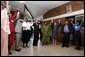 President George W. Bush, Mrs. Laura Bush, and to the President's right, Ugandan President Yoweri Museveni and Mrs. Museveni sing along with a choir and staff members of The AIDS Support Organization (TASO) Centre in Entebbe, Uganda Friday, July 11, 2003. White House photo by Susan Sterner.