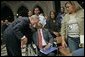 President George W. Bush greets one of the Hurricane Katrina evacuees attending the National Day of Prayer and Remembrance Service at the Washington National Cathedral in Washington, D.C., Friday, Sept. 16, 2005. White House photo by Eric Draper