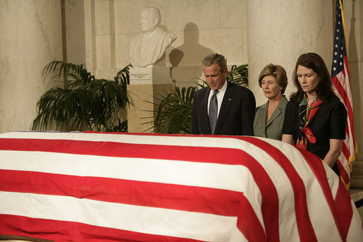 President George W. Bush and Laura Bush pay their respects to Chief Justice William Rehnquist as his body lies in repose in the Great Hall of the U.S. Supreme Court Tuesday, Sept. 6, 2005. Standing as honor guard for the Chief Justice is one of his former law clerks, Courtney Ellwood. White House photo by Eric Draper