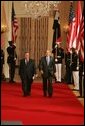 President George W. Bush and President Jalal Talabani of Iraq walk to the East Room of the White House Tuesday, Sept. 13, 2005, for a joint press availability. The President called Iraq "America's ally in the war against terrorism," and added, "freedom will win in Iraq." White House photo by Shealah Craighead