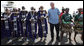 President George W. Bush is welcomed by Maasai dancers on his arrival Monday, Feb. 18, 2008 to the airport in Arusha, Tanzania. White House photo by Eric Draper