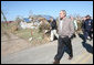 President George W. Bush walks a rubble-strewn stretch of highway in Lafayette, Tennessee Friday, Feb. 8, 2008, during his visit to the region that was hard hit by tornadoes earlier in the week. White House photo by Chris Greenberg