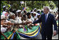 President George W. Bush reaches out to some of the hundreds of well-wishers in the ceremonial arrival cordon on hand to welcome him Sunday, Feb. 17, 2008, to the State House in Dar es Salaam, Tanzania. White House photo by Eric Draper