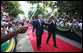 President George W. Bush and President Jakaya Kikwete of Tanzania acknowledge the crowd as they walk through the ceremonial arrival cordon Sunday, Feb. 17, 2008, at the State House in Dar es Salaam. White House photo by Eric Draper