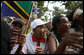 A young man waving a Tanzanian flag joins the well-wishers in the ceremonial arrival cordon Sunday, Feb. 17, 2008, to welcome President George W. Bush to Dar es Salaam. White House photo by Eric Draper