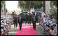 President George W. Bush is greeted by President Jakaya Kikwete of Tanzania, as he arrives at the State House in Dar es Salaam Sunday, Feb. 17, 2008. Hundreds of well-wishers joined the ceremonial welcome cordon to welcome President Bush. White House photo by Chris Greenberg