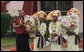 Flower girls await the arrival Saturday, Feb. 16, 2008, of President George W. Bush and Mrs. Laura Bush at Cadjehoun International Airport in Cotonou, Benin. The President and First Lady made the stop -- the first of their Africa visit – and spent the day before continuing on to Tanzania. White House photo by Shealah Craighead