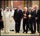 Vice President Dick Cheney and former President George H.W. Bush walks with newly crowned King Abdullah during a retreat at King Abdullah's Farm in Riyadh, Saudi Arabia Friday, August 5, 2005, following the death of his half-brother King Fahd who passed away August 1, 2005. Interpreter Gamal Helal, center, is also pictured. White House photo by David Bohrer