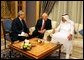 Vice President Dick Cheney speaks with newly crowned King Abdullah during a retreat at King Abdullah's Farm in Riyadh, Saudi Arabia Friday, August 5, 2005, following the death of his half-brother King Fahd who passed away August 1, 2005. Interpreter Gamal Helal, center, is also pictured. White House photo by David Bohrer