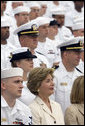 Laura Bush listens to President George W. Bush speak during a ceremony to commemorate the 60th anniversary of V-J Day at the Naval Air Station in San Diego, Calif., August 30, 2005. White House photo by Paul Morse