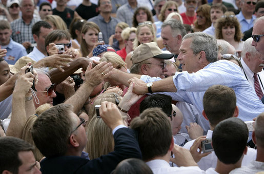 President George W. Bush greets the crowd after signing the Transportation Equity Act, at the Caterpillar facility in Montgomery, Ill., Wednesday, Aug. 10, 2005. White House photo by Eric Draper