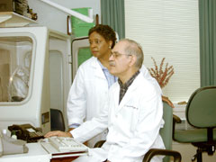 Physician and technician work looking at a computer interpreting pulmonary results