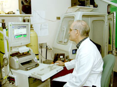 Photo of a physician sitting at a computer and interpreting a patient's exercise test.
