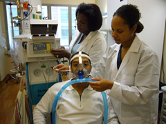 Nurses set up a patient to breathe nitric oxide.